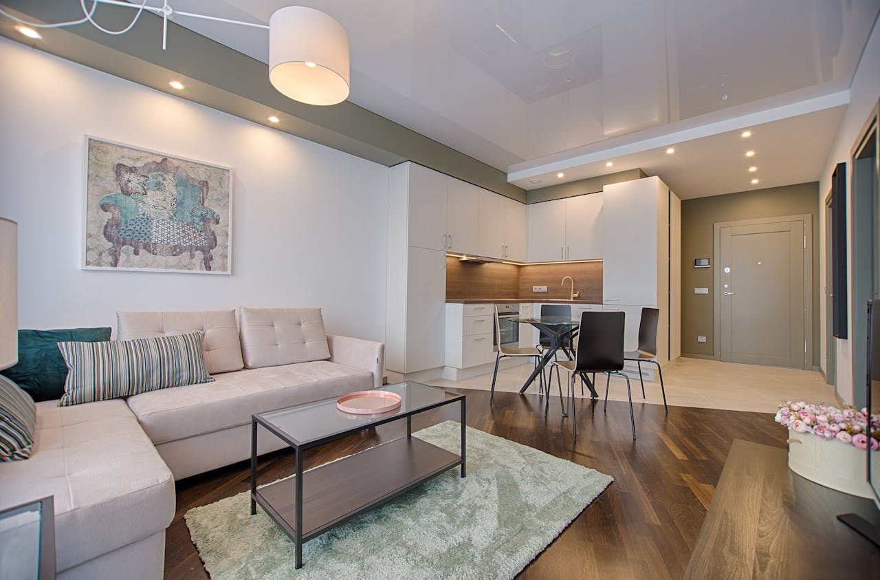 creative-02 Spacious modern living room featuring chic furniture, stylish decor, and a minimalist kitchen.