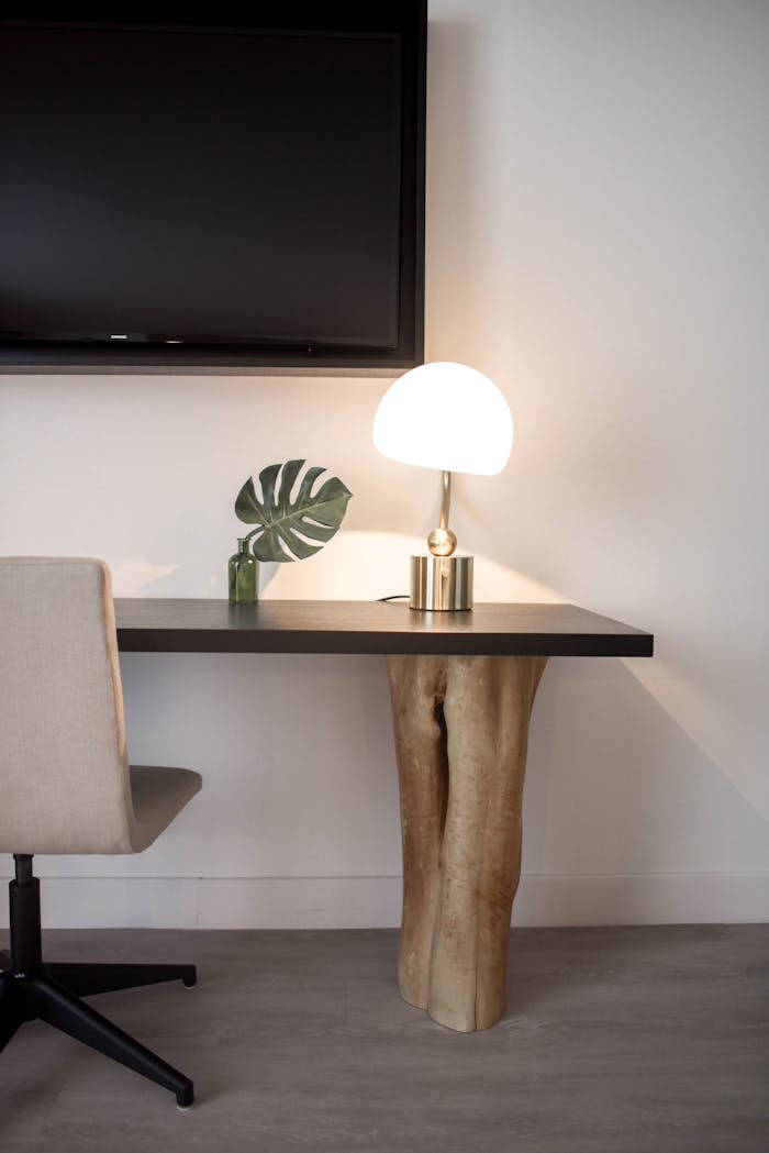 creative-03 Elegantly designed modern workspace featuring a unique wood table, chair, and lamp.